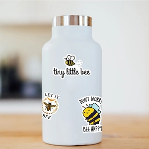 Close-up of waterproof bee-themed stickers on white bottle featuring tiny little bee designs