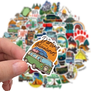 Close-up of waterproof camping sticker featuring retro green van and adventure slogan