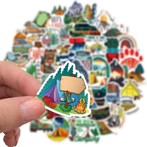 Close-up of waterproof outdoor camping stickers with tent and bonfire bonfire designs
