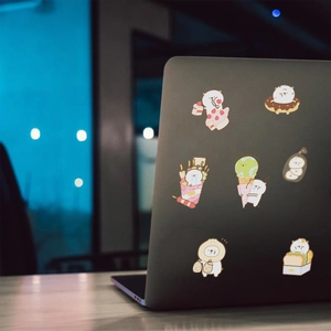 Cute white bear food graffiti stickers applied on a dark grey laptop surface