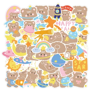 Detailed view of astronaut bear stickers featuring rockets and stars for laptop and DIY decor