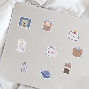 Cute cartoon bear stickers on a laptop cover showing waterproof PVC decorative decals