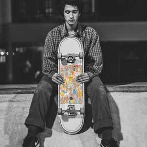 Skateboard deck decorated with vibrant cartoon bear and rainbow waterproof DIY stickers