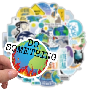 Close-up of a burning Earth sticker with Do Something text for climate change