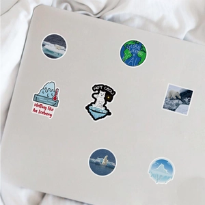 Climate change stickers shown on a laptop featuring polar bears and earth illustrations