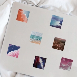 Artistic landscape stickers showing sunset and galaxy applied to a laptop cover
