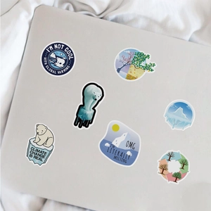 Detail of eco-friendly climate change stickers with polar bear and glacier on a laptop