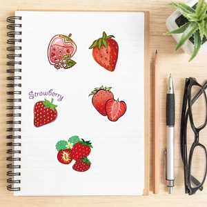 Detail of strawberry cartoon stickers on a white notebook for DIY decoration