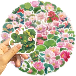 Close-up of waterproof pink lotus flower stickers for laptops and journals held by hand