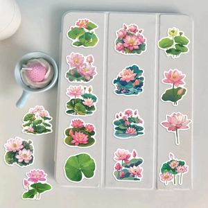 Detail shot of pink lotus flower stickers arranged on an iPad case with a decorative cup