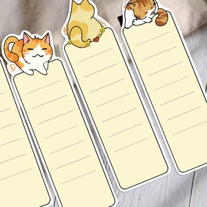Set of 30 cute cartoon cat paper bookmarks for reading with writing lines on wood desk