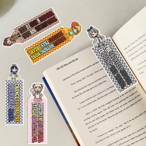 Detailed shot of five cartoon bookmarks with motivational quotes on a vintage book background
