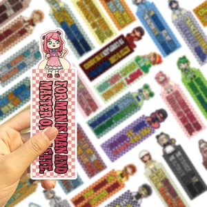 Close-up of cute cartoon bookmarks with inspirational quotes and pink checkered patterns