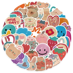 Close-up of matte cartoon bear and rabbit stickers with colorful doodle designs