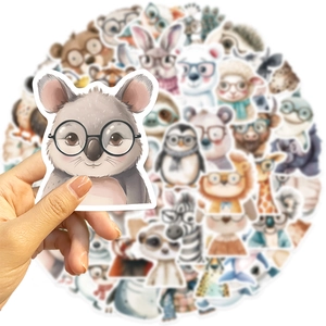 Close-up of hand holding a cute koala sticker with glasses from an animal sticker pack