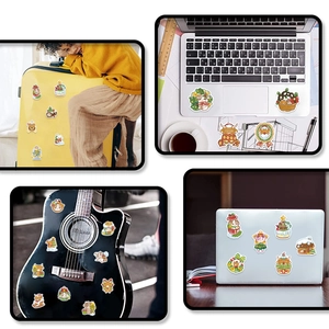 Detailed holographic Christmas stickers applied to laptops and suitcases for decoration