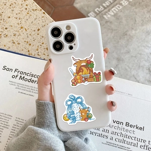 Detail of Christmas bull cartoon design on white smartphone case held in hand