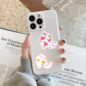 Detail shot of cute cat and flower illustrations on a white protective phone case