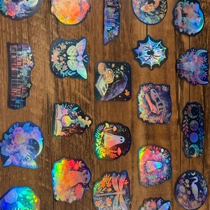 Holographic decorative stickers with fantasy patterns on a wooden surface detail