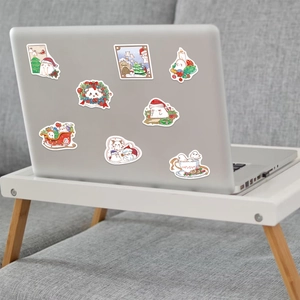 Waterproof Christmas ghost stickers applied on a laptop for DIY festive decoration