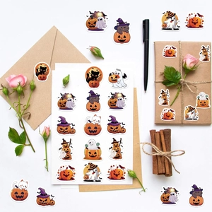 Flat lay of Halloween pumpkin and ghost stickers decorating envelopes and gift boxes