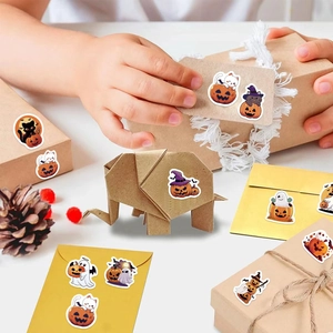 Roll of cartoon Halloween stickers featuring pumpkins, ghosts, and cats for gift decor