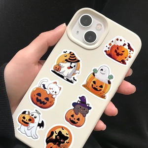 Detailed view of cute Halloween stickers featuring pumpkins and ghosts on a beige phone case