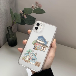 Detailed view of clear iPhone case with Japanese architecture illustrations on wooden table