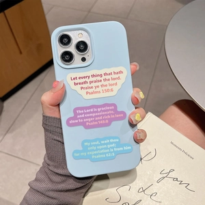 Close-up of light blue phone case featuring religious Bible Psalm stickers held by a hand