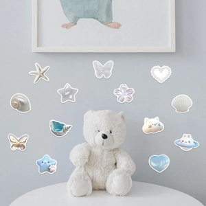 Close-up of 3D dreamy galaxy themed stickers with pearlescent finish on a blue wall