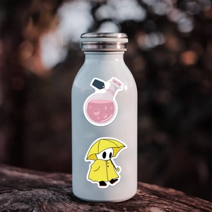 Close-up of waterproof cartoon potion and raincoat stickers on a white water bottle