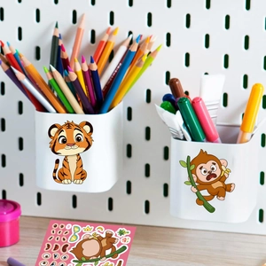 DIY cartoon animal stickers featuring tigers and monkeys applied to a white pencil holder