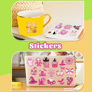 Detail of pink Halloween stickers applied on yellow mug, laptop, and white notebook