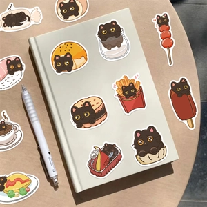Simpatici adesivi gatto nero cibo su un quaderno per decorazioni fai-da-te e journaling creativo