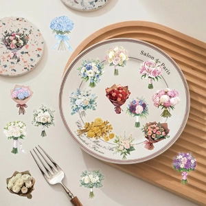Detail showing various waterproof floral PET stickers on a white porcelain plate