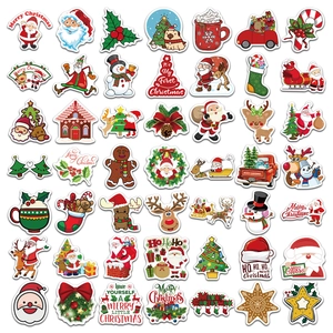 Flat lay of 50 cartoon Christmas stickers featuring Santa, reindeer and trees for DIY decoration