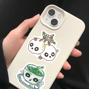 Detail of cream iPhone case featuring groovy skull and cherry cartoon illustrations