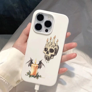 Close-up of matte white iPhone case featuring dark skull candle and wing illustrations