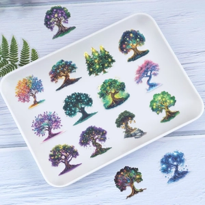 Macro shot of 16 assorted fantasy magic tree stickers in a white ceramic tray decoration