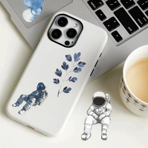 Close-up of white iPhone case featuring blue floral motifs and astronaut illustrations