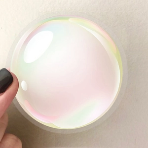 Close-up of holographic iridescent round stickers with pearlescent gradient finish