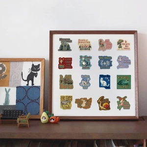 Close-up of vintage aesthetic stickers with philosophical quotes on a wooden shelf display