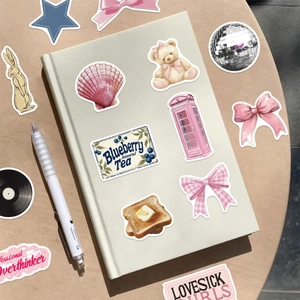 Creative lifestyle shot of cartoon stickers decorated on a notebook with warm wood background