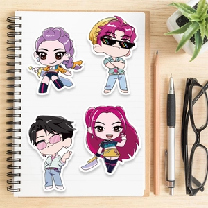 DIY cartoon character stickers shown on a notebook with stationery in a cozy setting