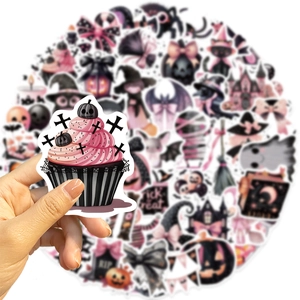 Close-up of a pink and black Halloween cupcake sticker with ghosts and bats motifs
