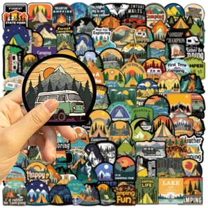 Close-up of waterproof camping stickers showing forest and RV motifs for DIY decor