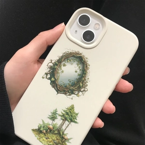 Close-up of hand holding a cream phone case with forest illustration for iPhone model
