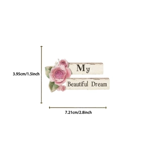 Close-up of decorative floral art plaque with pink roses and Beautiful Dream text