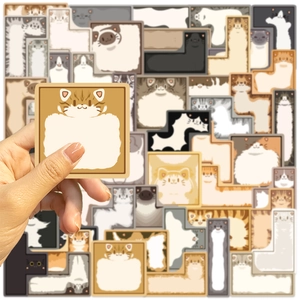 Detail view of cute cartoon cat-themed memo pads in various shapes held in hand