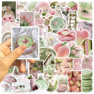 Close-up of pink and green dreamlike girlhood aesthetic stickers for journals and laptops